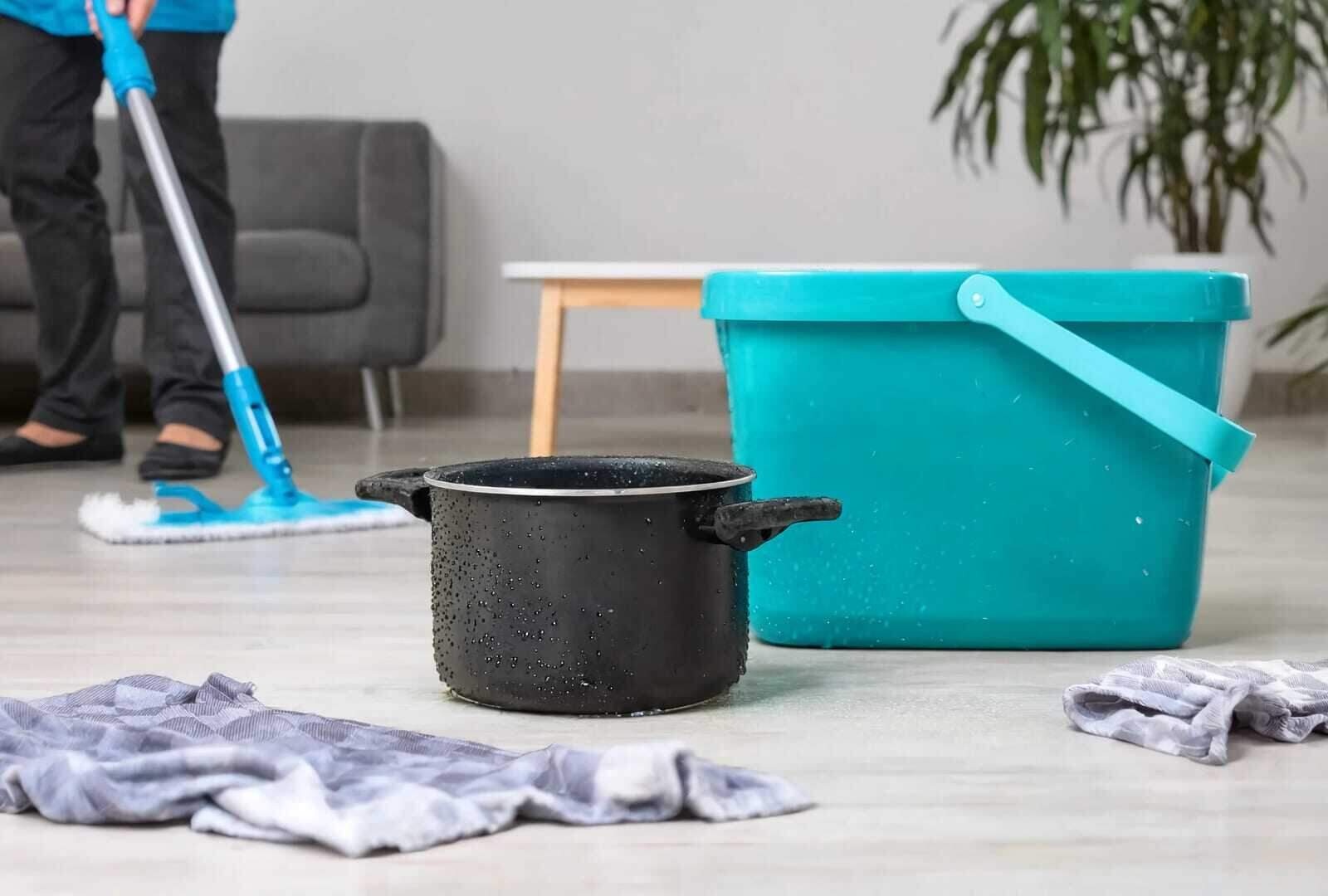 Mopping and drying a wet floor after a small household water leak